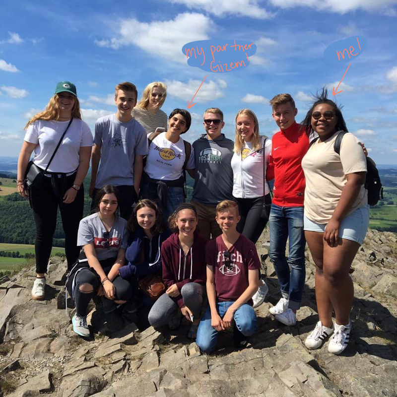 Jordan poses together with a group of other German learners outdoors