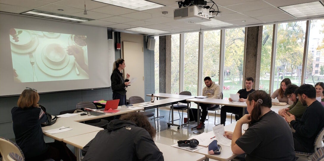 Instructor and students at a class meeting in GH 207. A video is being projected.