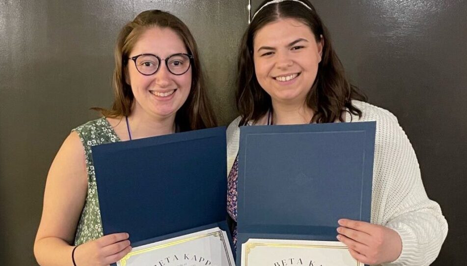 Chloe and Eliza smiling and holding Phi Beta Kappa certificates